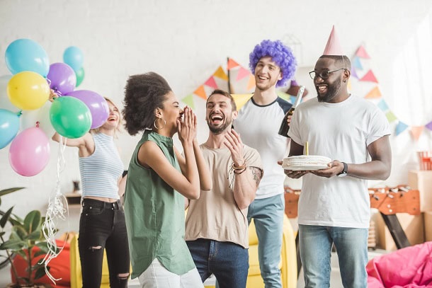 Friends having fun at the party of a woman who is having her birthday celebration.