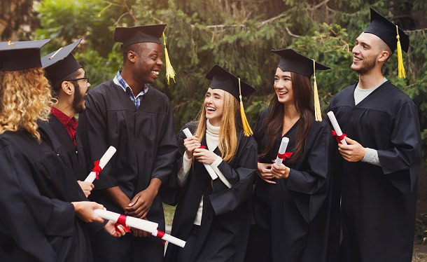 Happy graduating students laughing after their ceremony.