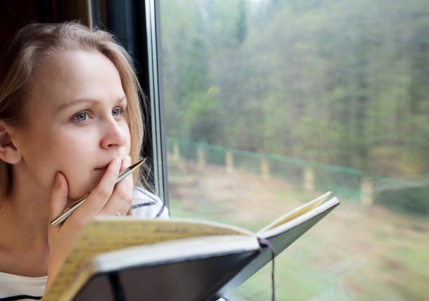 A woman thinking about something while riding the train.