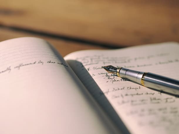 A pen resting in a notebook.