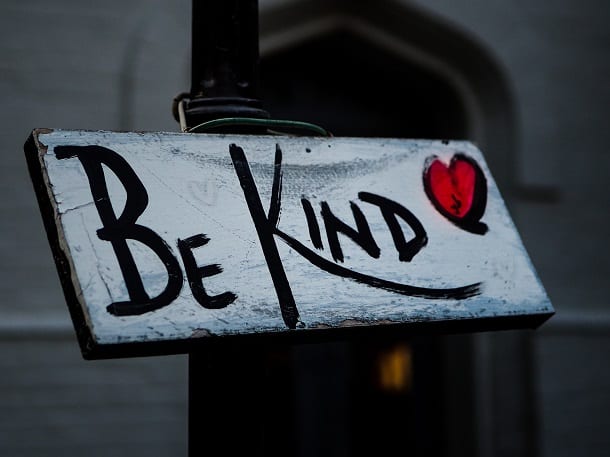 A sign that says Be Kind and a drawn heart.