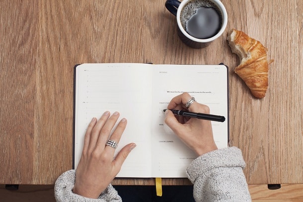 A woman writing in a notebook.