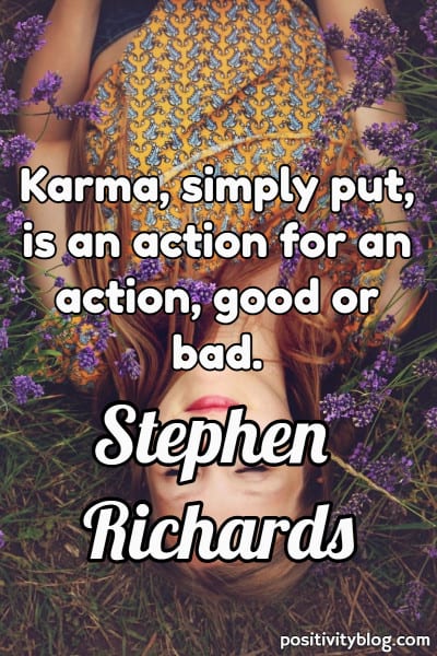 An image of a woman lying in grass with a quote about karma and cheating.