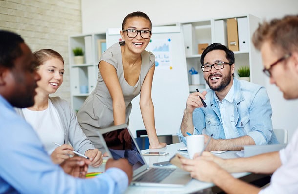 People in a good mood in an office meeting.