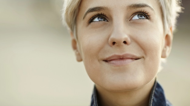 A smiling woman looking up.