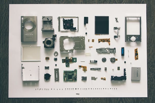 An image of a digital camera taken apart into its individual pieces.